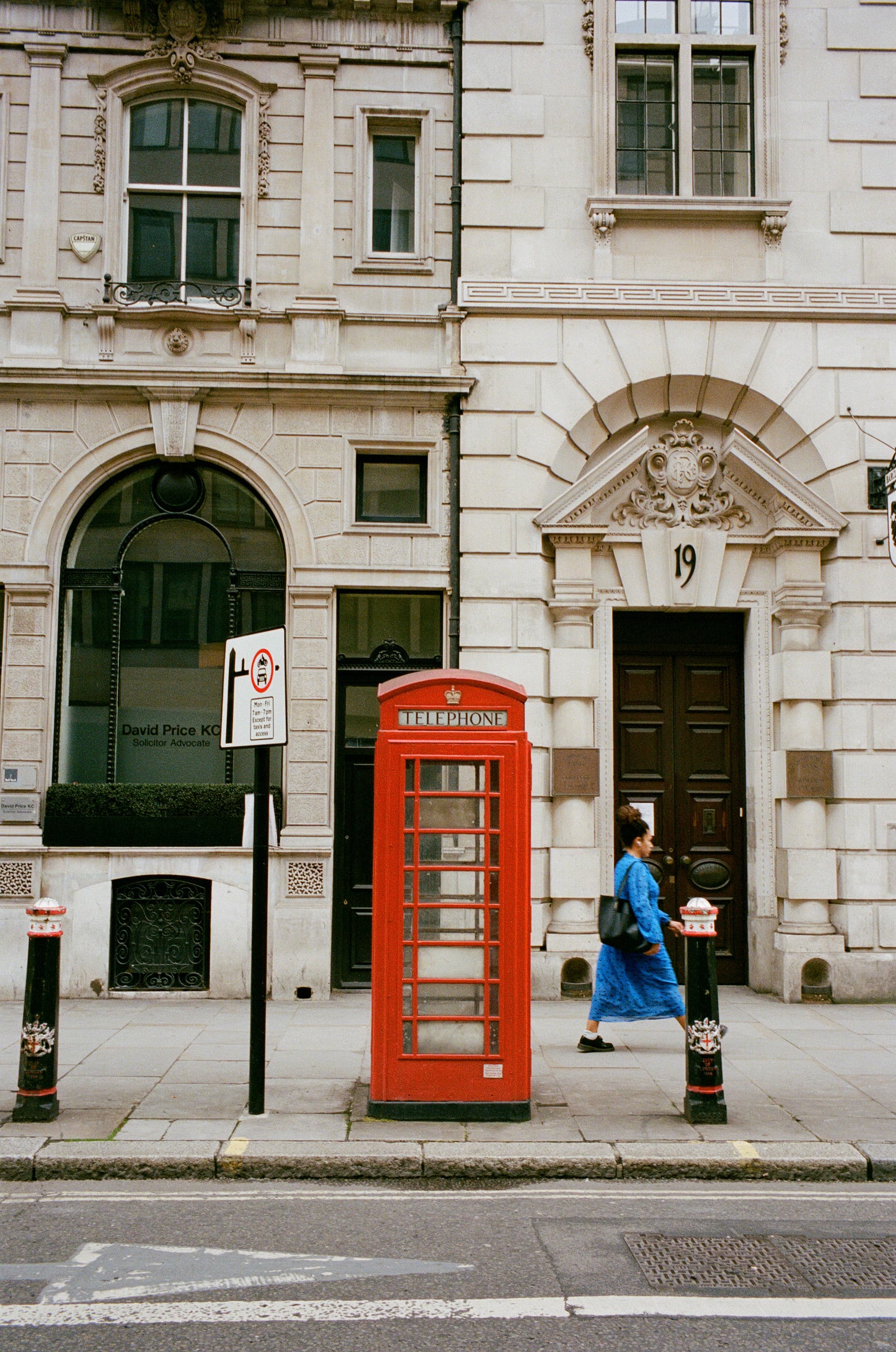 a telephone booth on a sidewalk of london